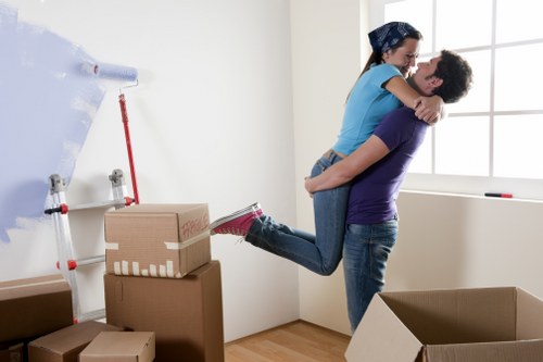 Professional movers transporting boxes and furniture in a South Kensington flat