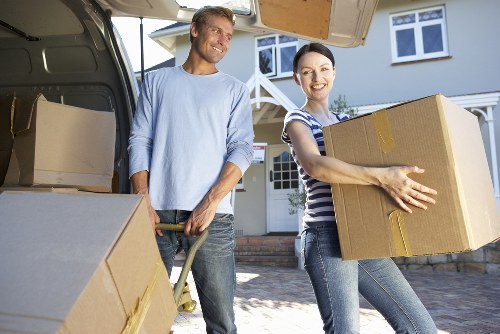 Movers handling furniture through a period property in South Kensington