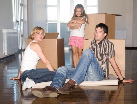 Professional removals team handling household items in a central London property